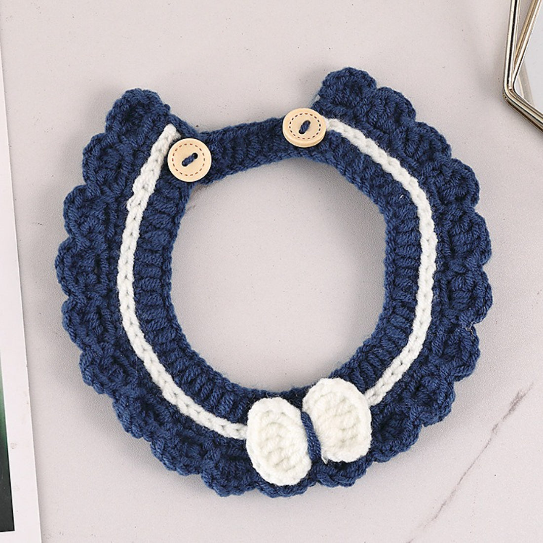 Mokka button crochet cat collar coiled with visible button and bell