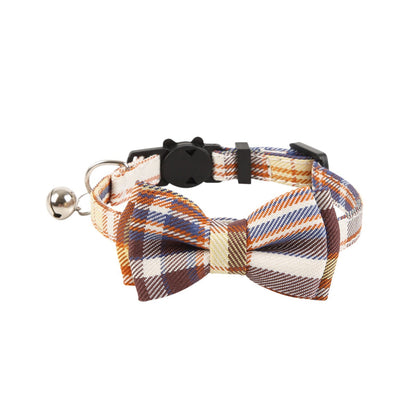 Mokka plaid bow cat collar with bell shown from above on plain surface
