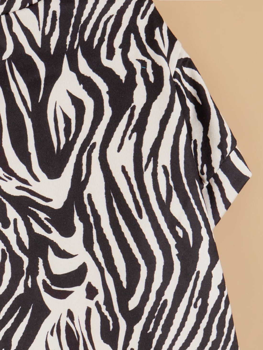 Close-up of dog’s neck and chest in Ozzie zebra print t-shirt
