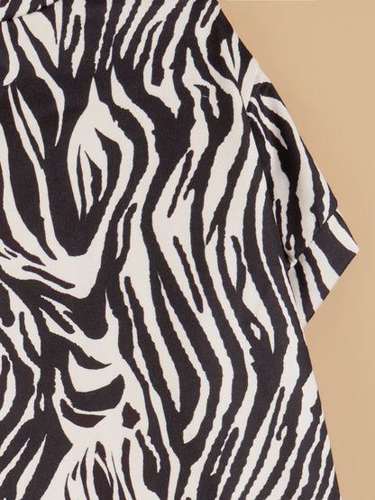 Close-up of dog’s neck and chest in Ozzie zebra print t-shirt