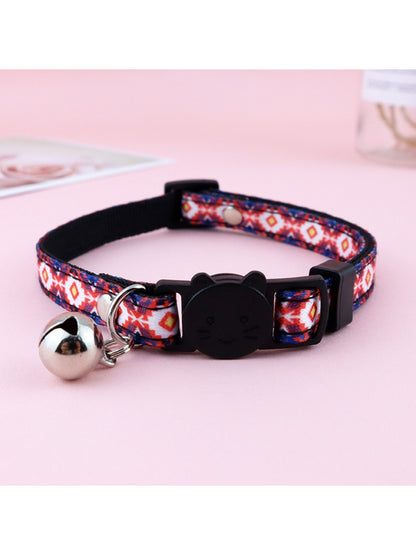 Mokka floral print bell cat collar coiled with bell and buckle in focus