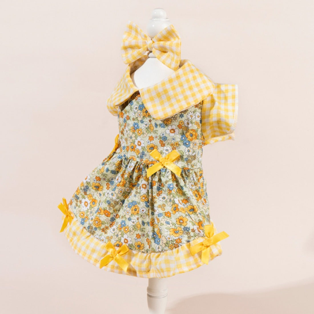 Full body shot of dog in Ozzie floral dress with bow on back