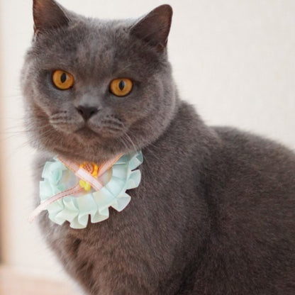 Close-up of pastel ribbon cat bib showing delicate fabric texture and stitching