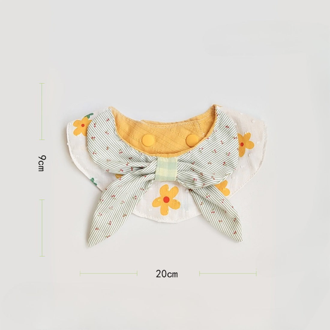 Close-up of sunflower pattern on Mokka gingham cat bib