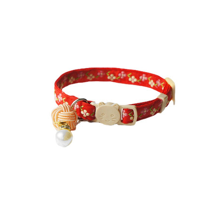 Mokka Pearl Flower Cat Collar shown coiled with visible flower decoration