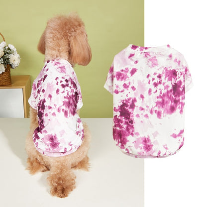 Dog standing outdoors wearing a bright tie dye t-shirt with a relaxed fit
