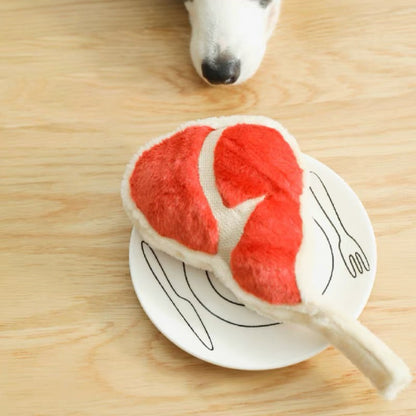Ham-shaped plush dog toy with cartoon-style embroidery on white background
