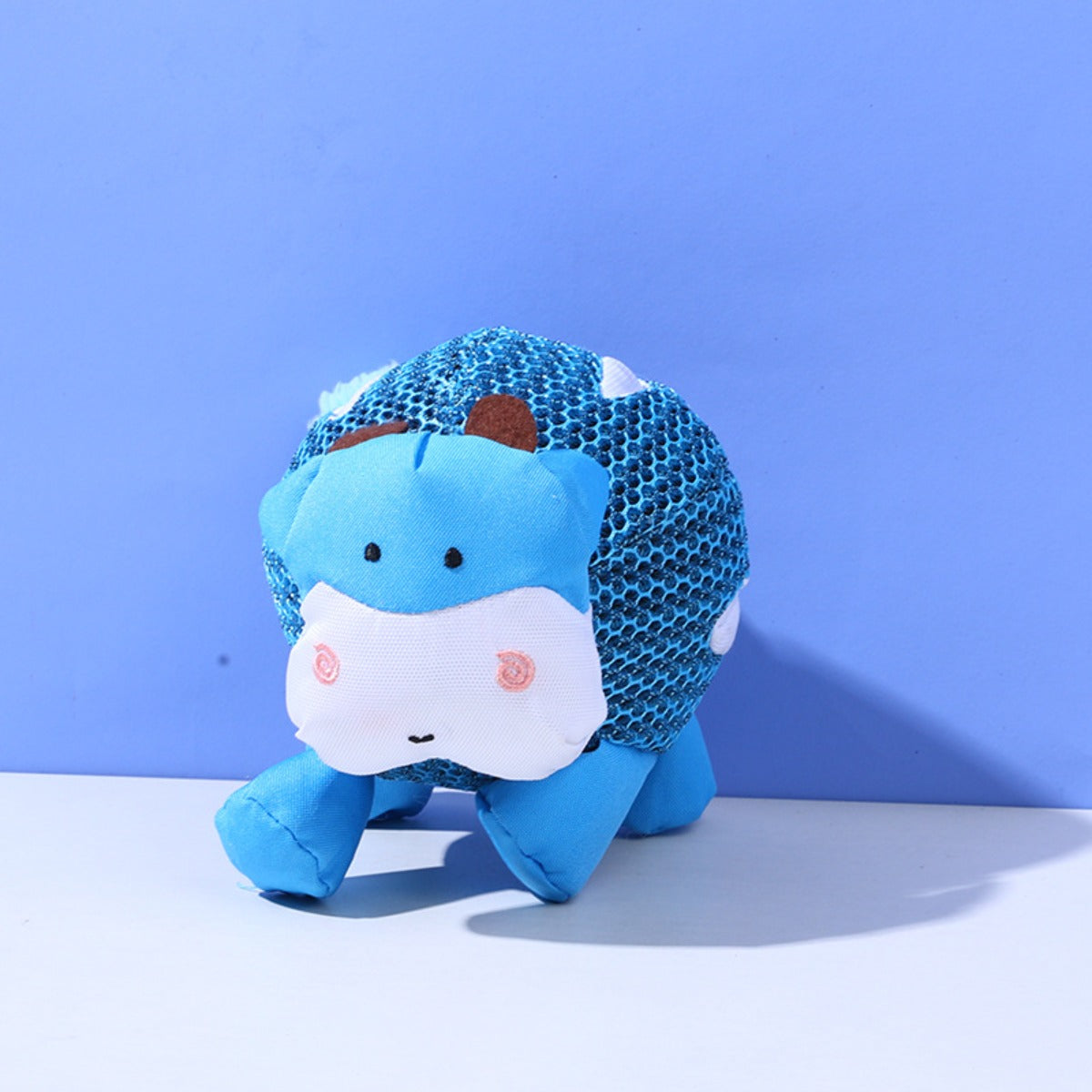 Petkin dog toy held in hand to show size and softness of the plush material