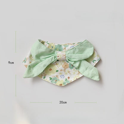 Side view of cat wearing Mokka flower print neck bib
