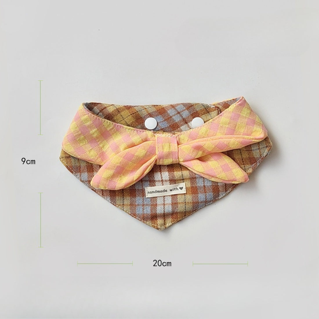 Close-up of the layered plaid fabric and stitching on the Mokka cat bib