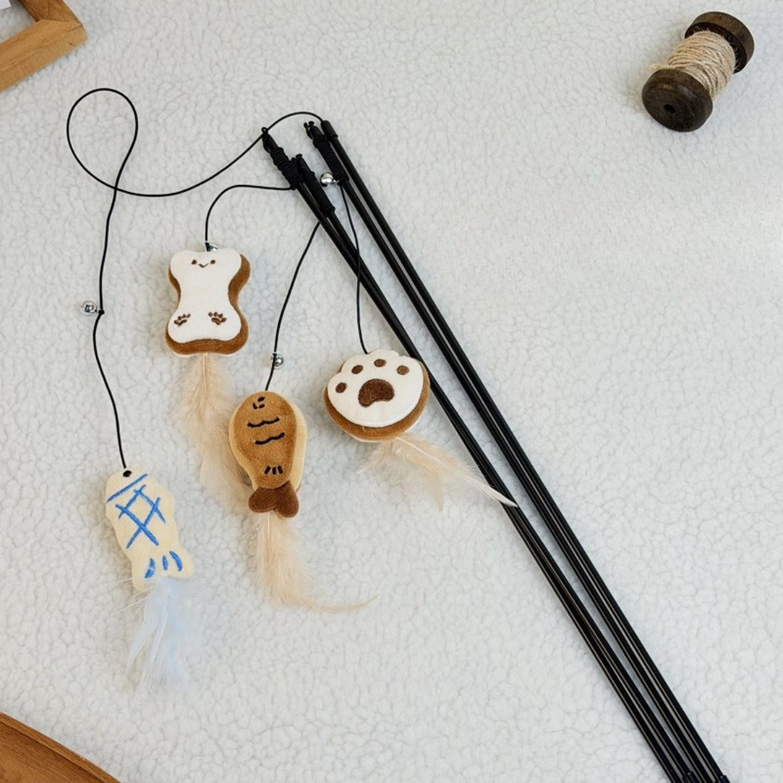Moo Cookie plush cat teaser wand with brown cookie-shaped plush and attached feathers