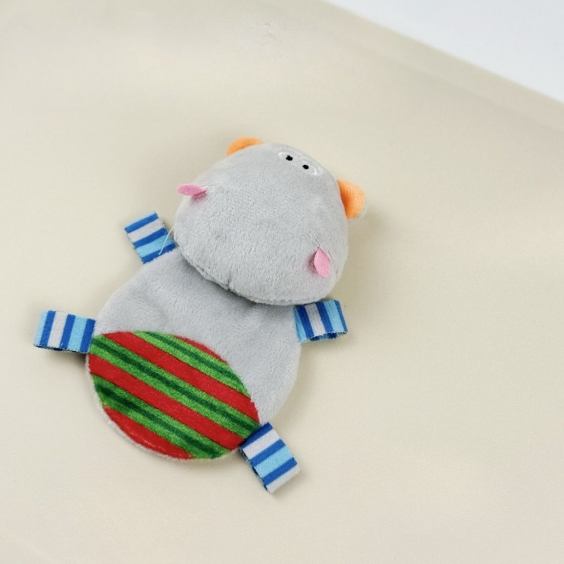 Close-up of Moo hippo cat plush toy showing embroidered eyes and nose details