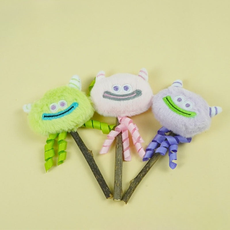 Close-up of Moo monster cat toy showing detailed monster face and soft feathers