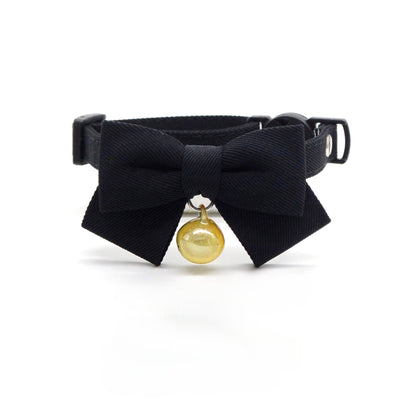 Cat wearing Mokka solid brown bow breakaway collar outdoors