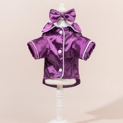 Back view of a dog in a satin shirt featuring a prominent bow