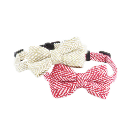 Mokka cat collar with herringbone bow tie partially unrolled on flat surface
