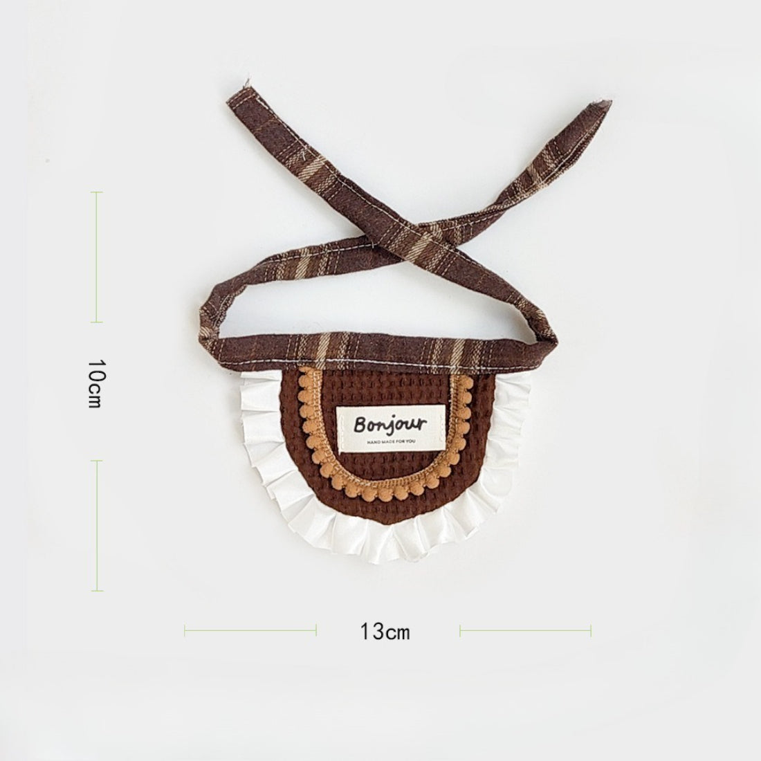Brown ruffle cat bib folded neatly on a flat surface