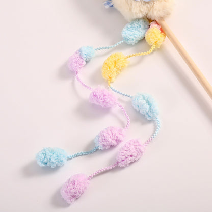 Side view of Moo plush cat teaser wand toy showing wooden stick and attached plush feathers