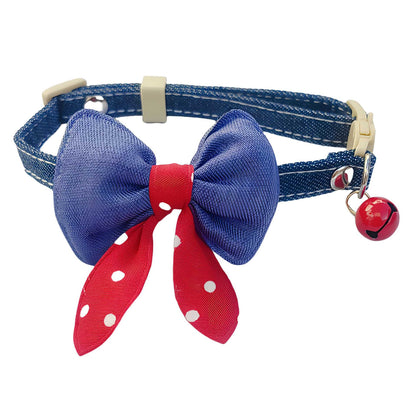 Mokka polka dot bow cat collar with bell wrapped around a cylindrical object