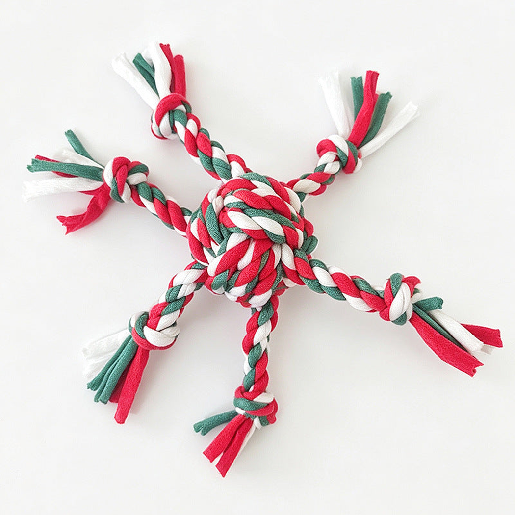 Red, green, and white braided rope dog toy with a central knot and tassel ends