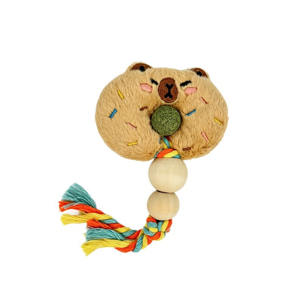 Capybara cat toy with an embroidered face, central green ball, two rounded beads and a multicolored braided tassel.