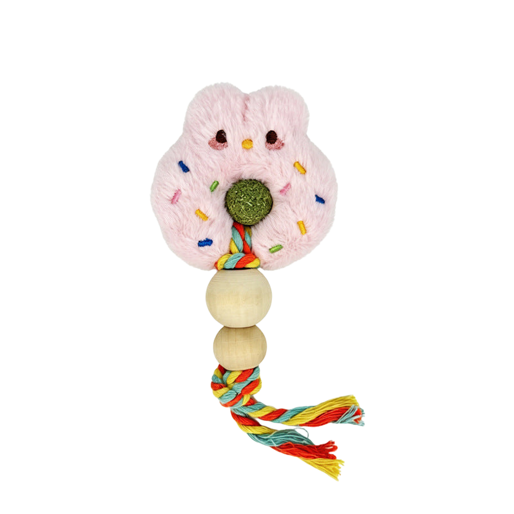 Rabbit cat toy with upright pink ears, a central green ball, two rounded beads and a multicolored braided tassel.