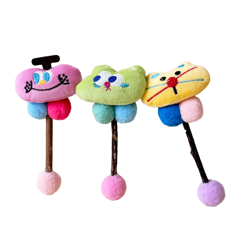 Apple, Rabbit and Cat toys with stitched faces, colored balls and sticks.