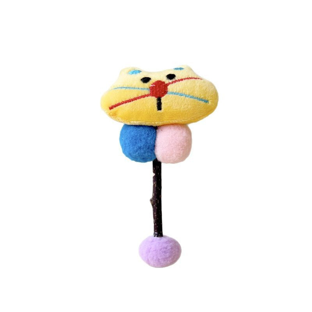 Yellow Cat toy with a stitched face, blue and pink balls, and a purple ball at the end of its stick.