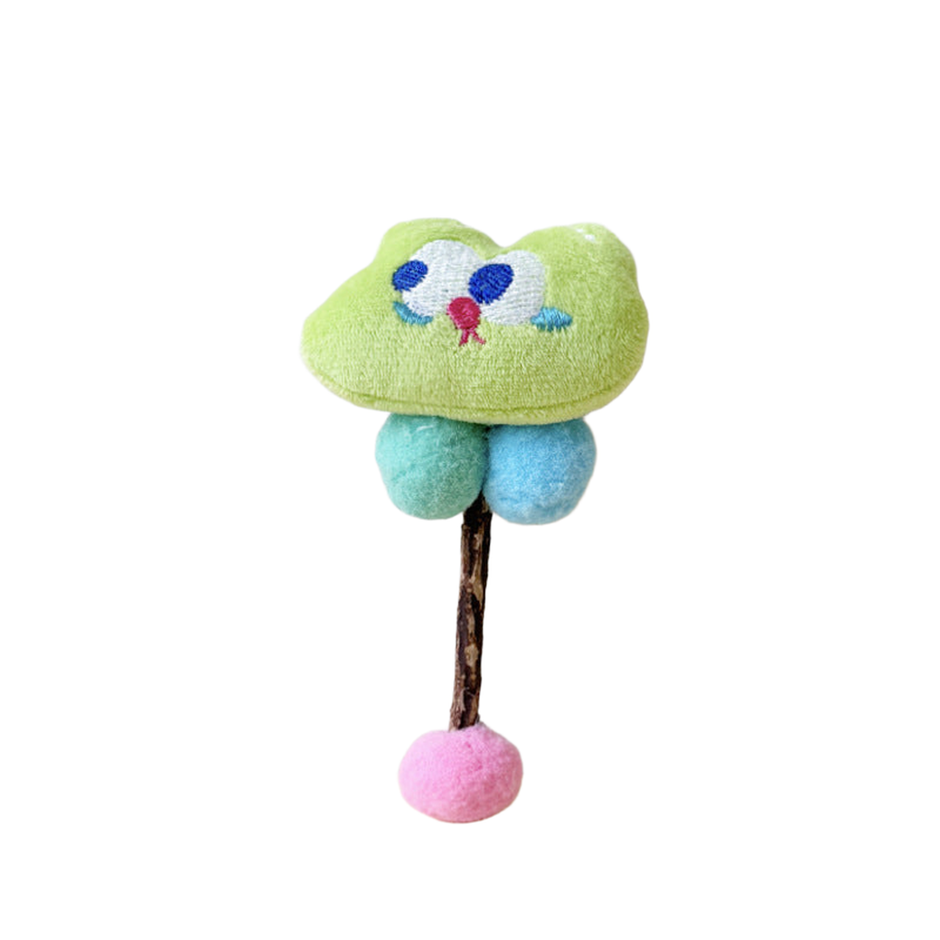 Green Rabbit toy with large stitched eyes, turquoise and blue balls, and a pink ball at the end of its stick.