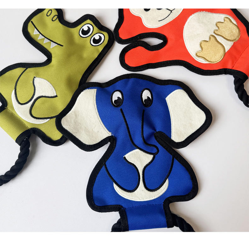 Close-up of the appliqué faces on the crocodile, monkey and elephant dog toys