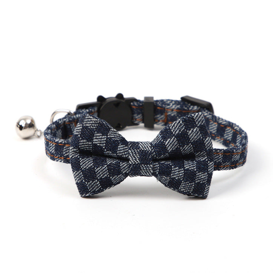 Navy plaid pet collar with centered bow and bell, front view