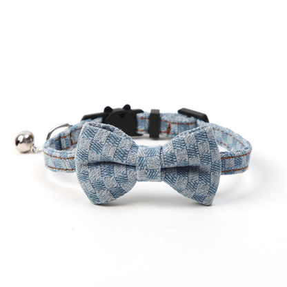 Light blue plaid pet collar with centered bow and bell, front view