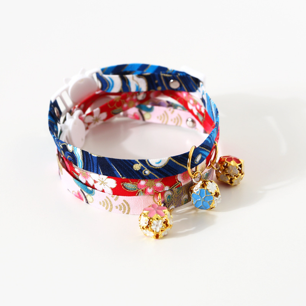 Three floral cat collars displayed together with decorative bells