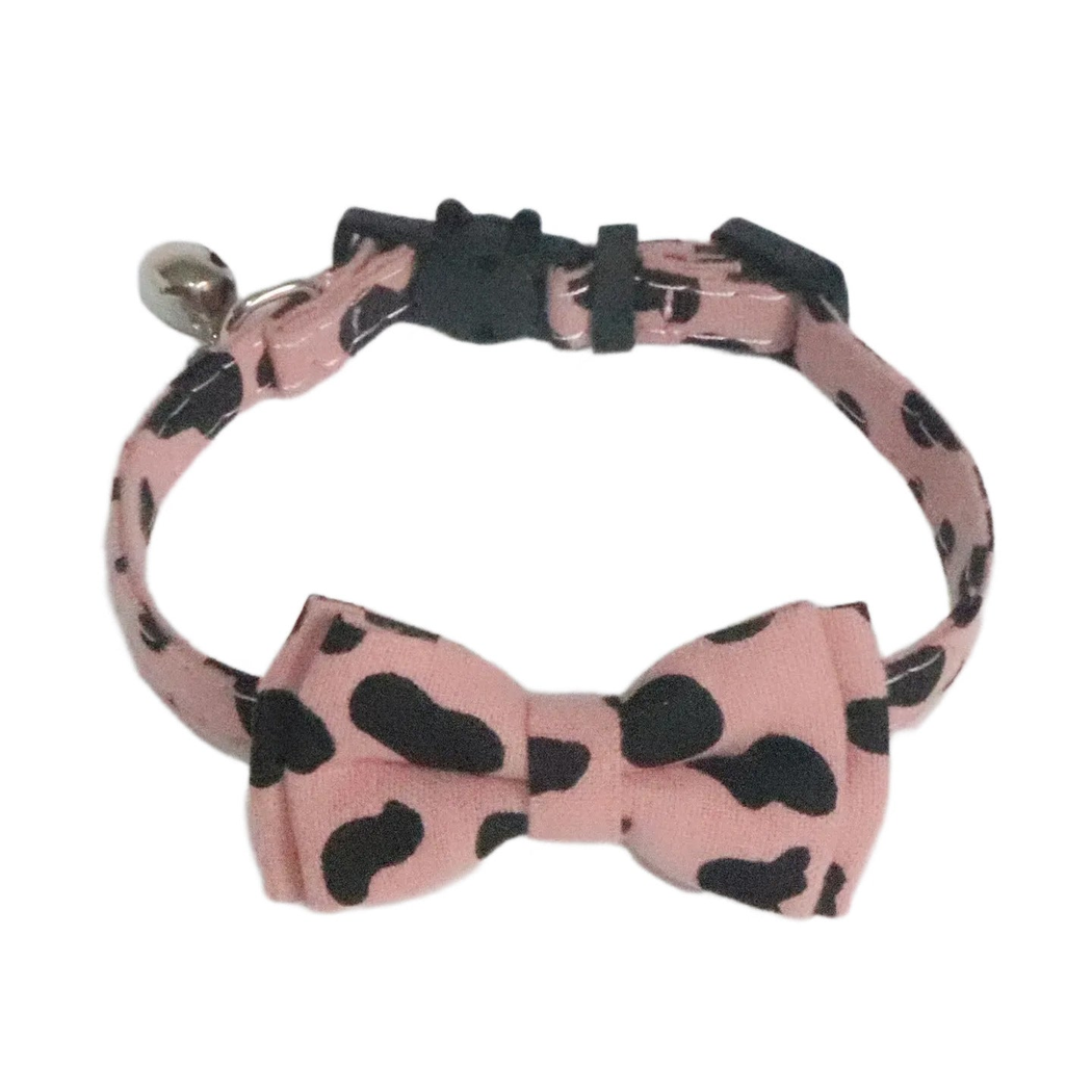 Dusty pink cow-print cat collar with black-spotted bow tie and bell
