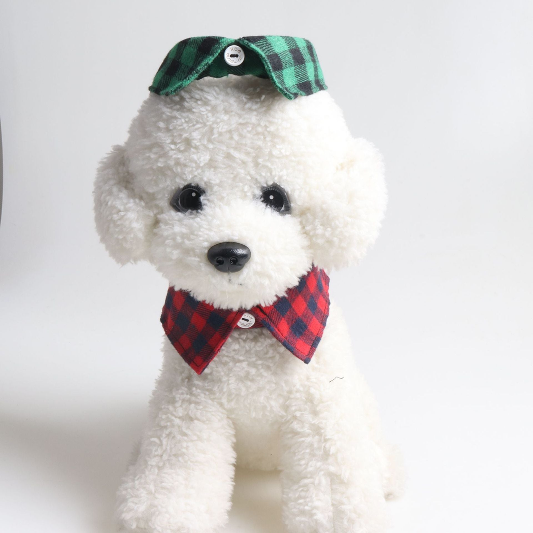 Red and navy plaid bow collar styled around a white plush animal with a green plaid collar above