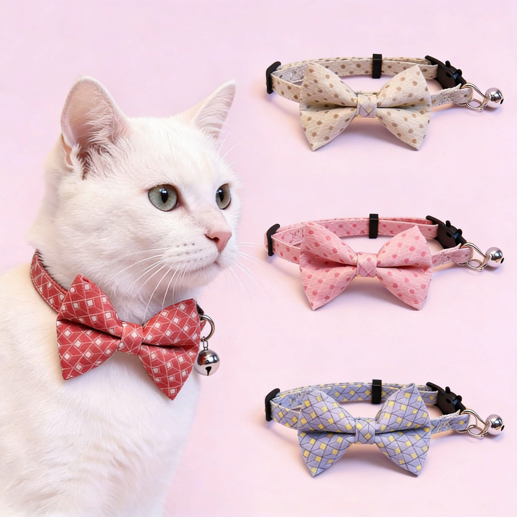 White cat wearing a red geometric bow cat collar with bell beside four color options