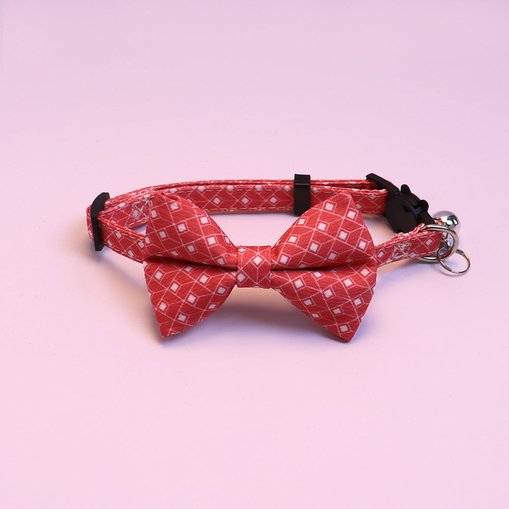 Red geometric bow cat collar with bell, front view