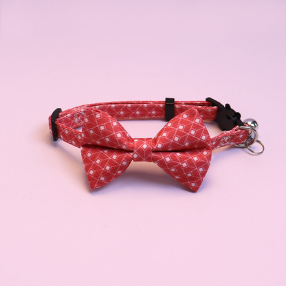 Red geometric bow cat collar with bell, front view