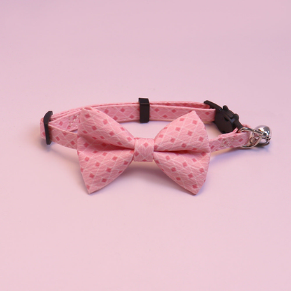 Pink geometric bow cat collar with bell, front view