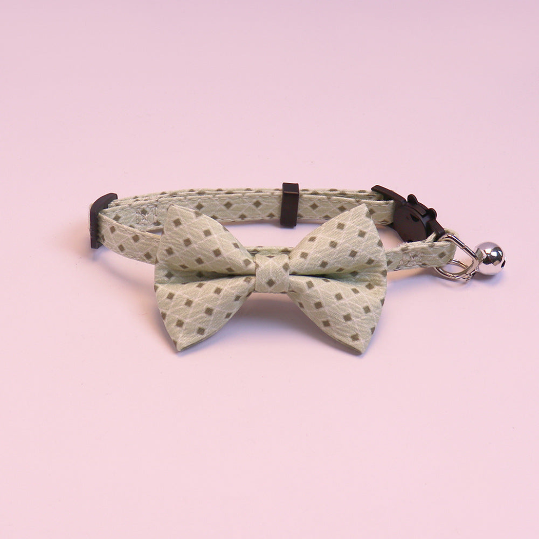 Light green geometric bow cat collar with bell, front view