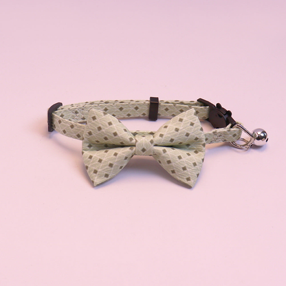 Light green geometric bow cat collar with bell, front view