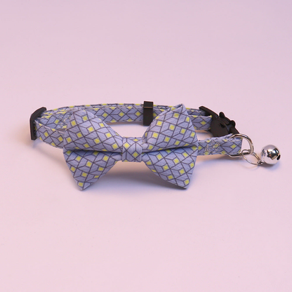 Blue geometric bow cat collar with bell, front view