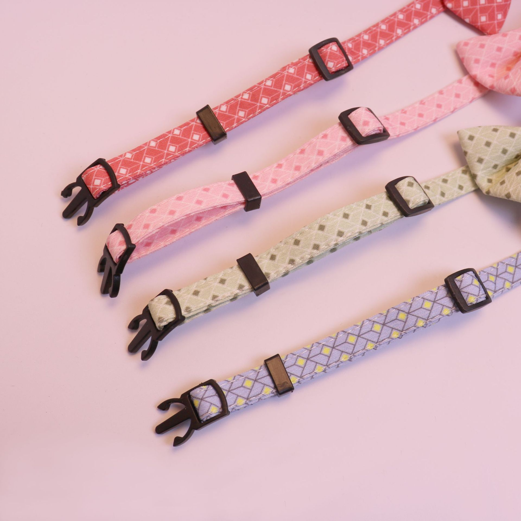 Close-up of sliding adjusters and retaining loops on four patterned cat collar bands