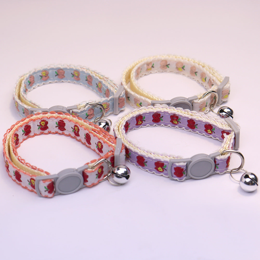 Four apple-pattern cat collars with gray buckles and silver-tone bells