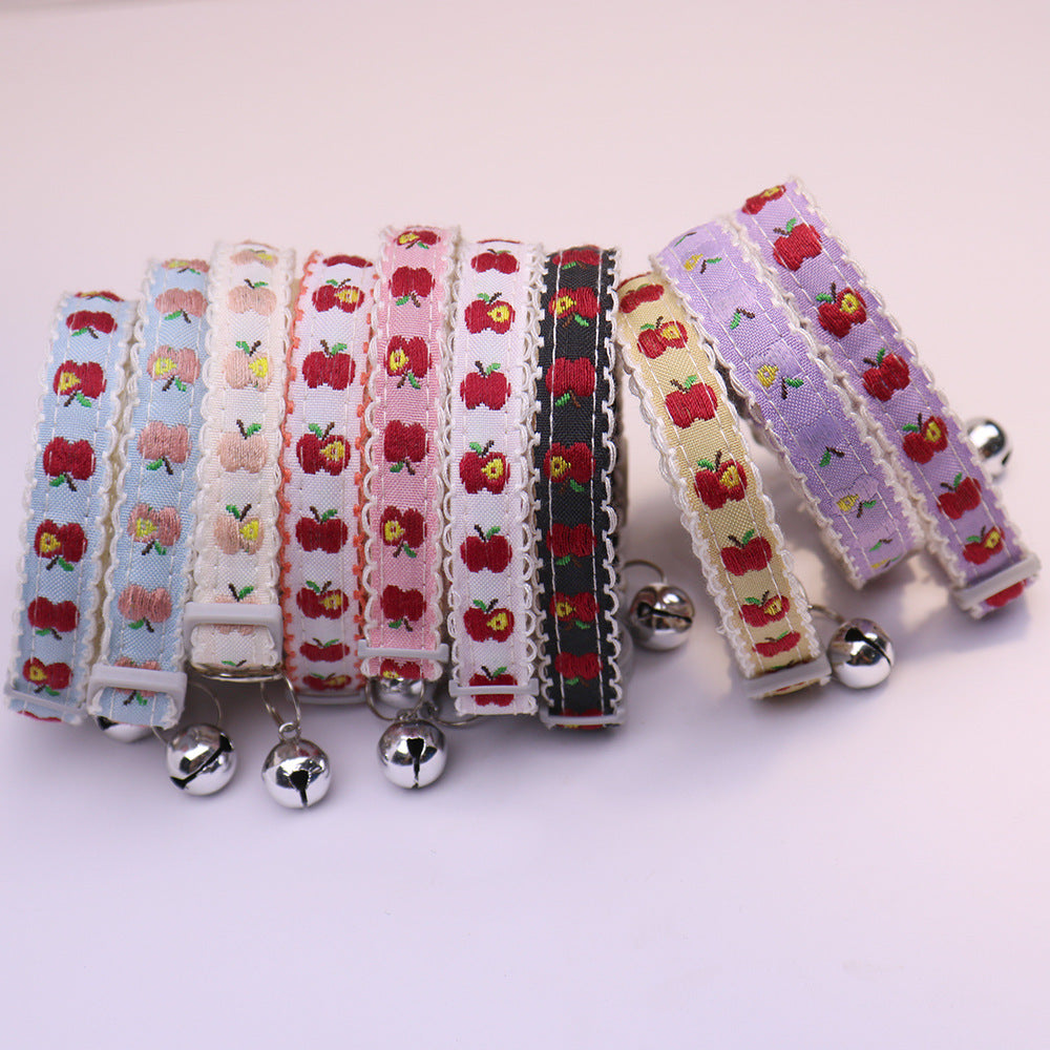 Assorted apple-pattern cat collars arranged side by side