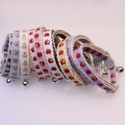 Assorted apple-pattern cat collars in a curved group display