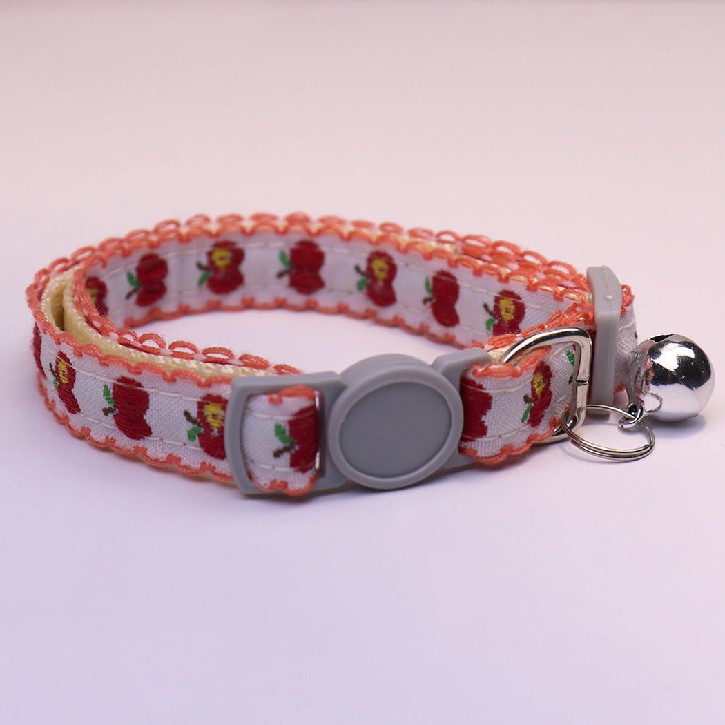 Orange-edged apple-pattern cat collar with gray buckle and bell