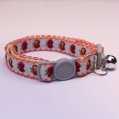 Orange-edged apple-pattern cat collar with gray buckle and bell