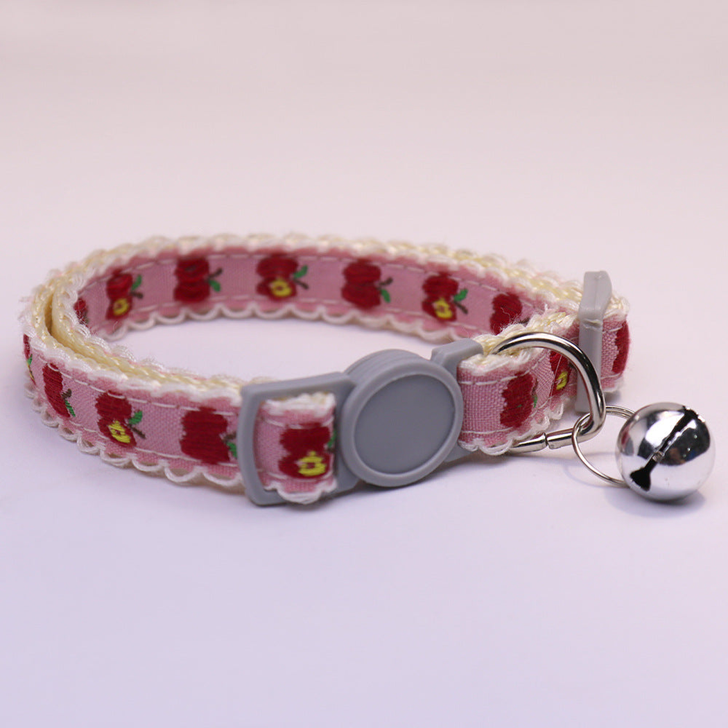 Pink apple-pattern cat collar with gray buckle and bell