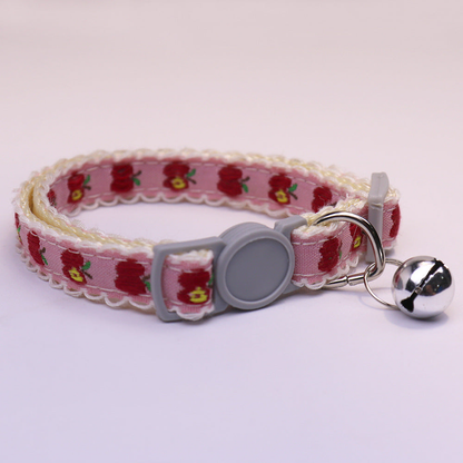 Pink apple-pattern cat collar with gray buckle and bell